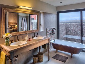 Immerse yourself in the elegant ambiance of Red Stag Patagonia's bathroom, designed to provide a serene retreat