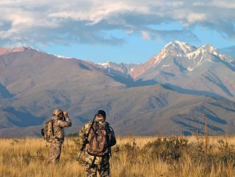 Two men engrossed in their road of the expedition, attentively observing their surroundings for their next target.