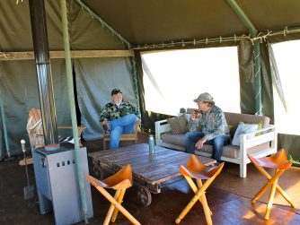 Discover the stories and shared experiences as two men connect and exchange tales inside a tent, embracing the spirit of adventure at Red Stag Patagonia