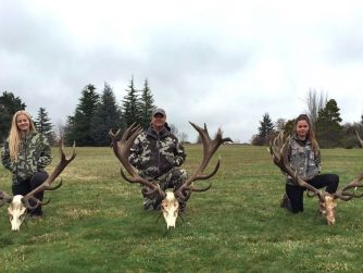 Experience the thrill of the hunt with Red Stag Patagonia, as men proudly display a magnificent deer antler, capturing the essence of their outdoor adventure