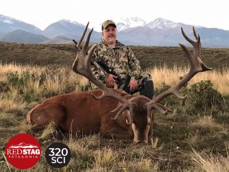 Red Stage tupungato: Celebrating the Skill and Determination of a Man Posing with His Hunting Rewards.